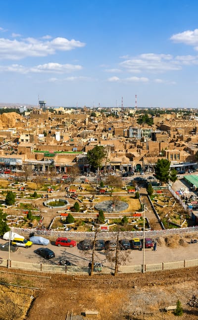 Herat, Afghanistan, old city of mud-brick buildings with the Friday Mosque's minarets rising on the right.