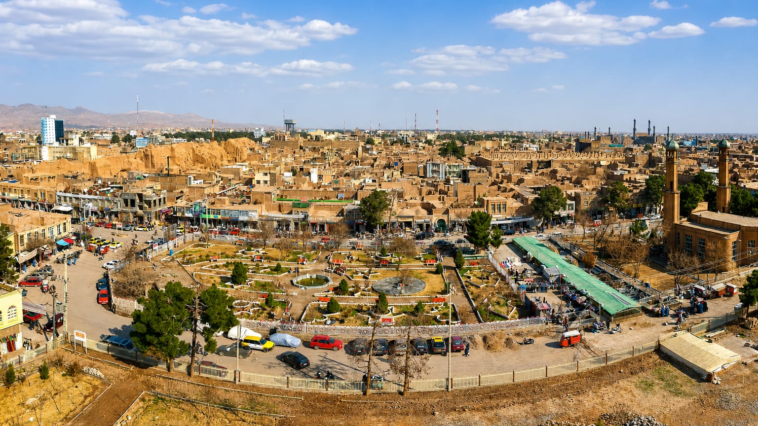 Herat, Afghanistan, old city of mud-brick buildings with the Friday Mosque's minarets rising on the right.