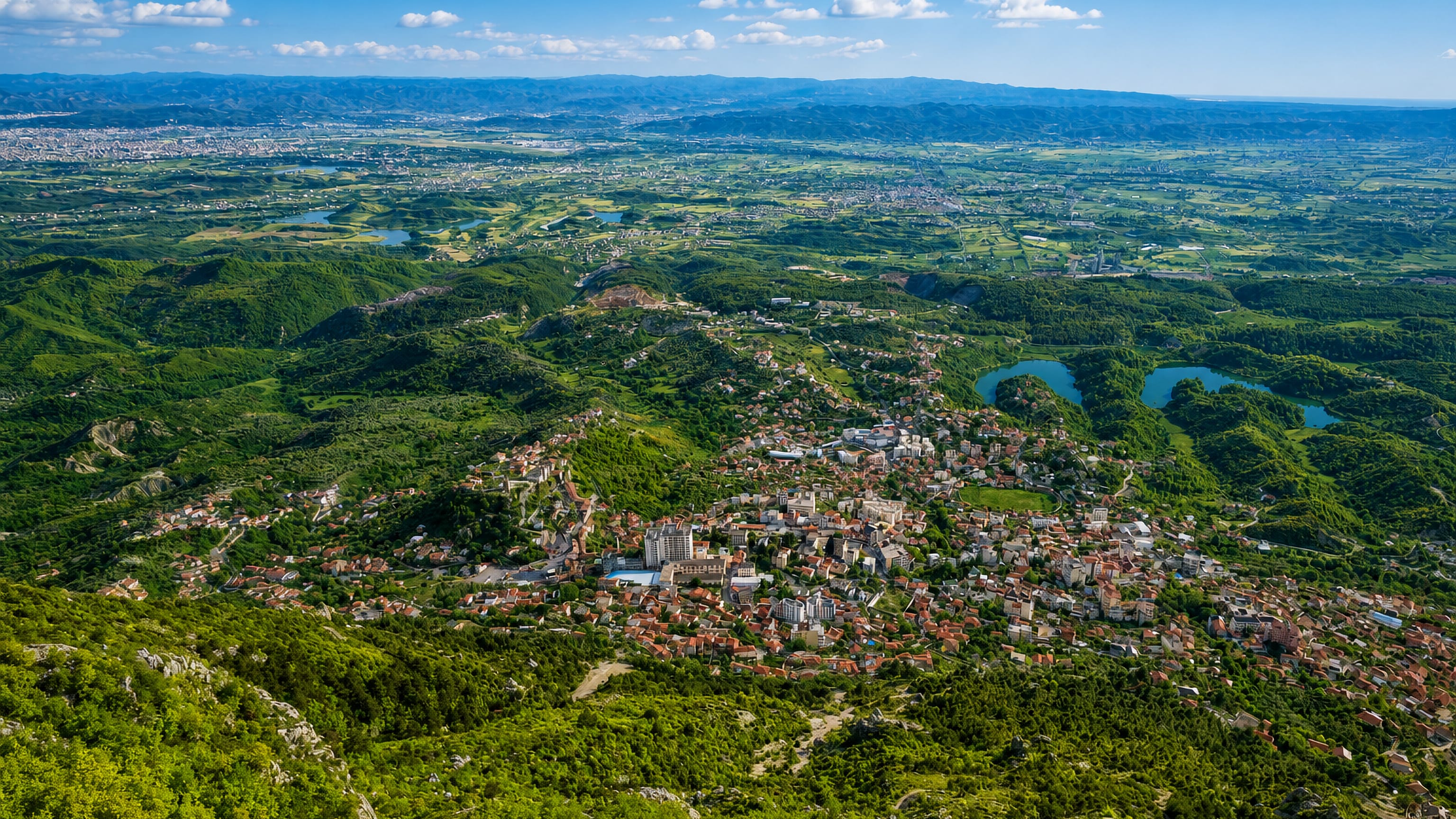 Krujë spilling down its green Albanian hillside above the coastal plain and distant mountains