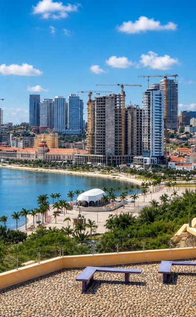 Luanda's bayfront skyline and palm-lined Marginal seen from the yellow Fortress of Sao Miguel