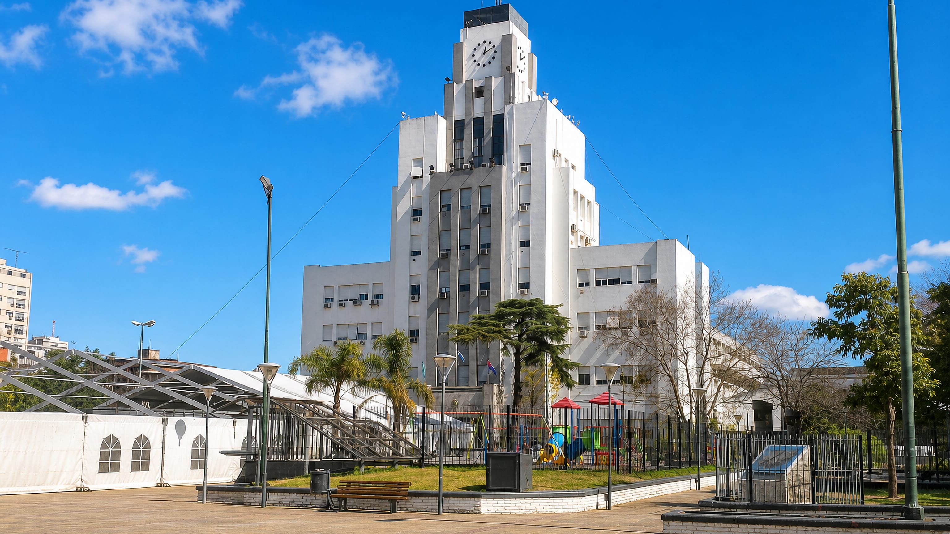 The white Art Deco municipal palace and clock tower of Lomas de Zamora, Argentina, seen from its public plaza.