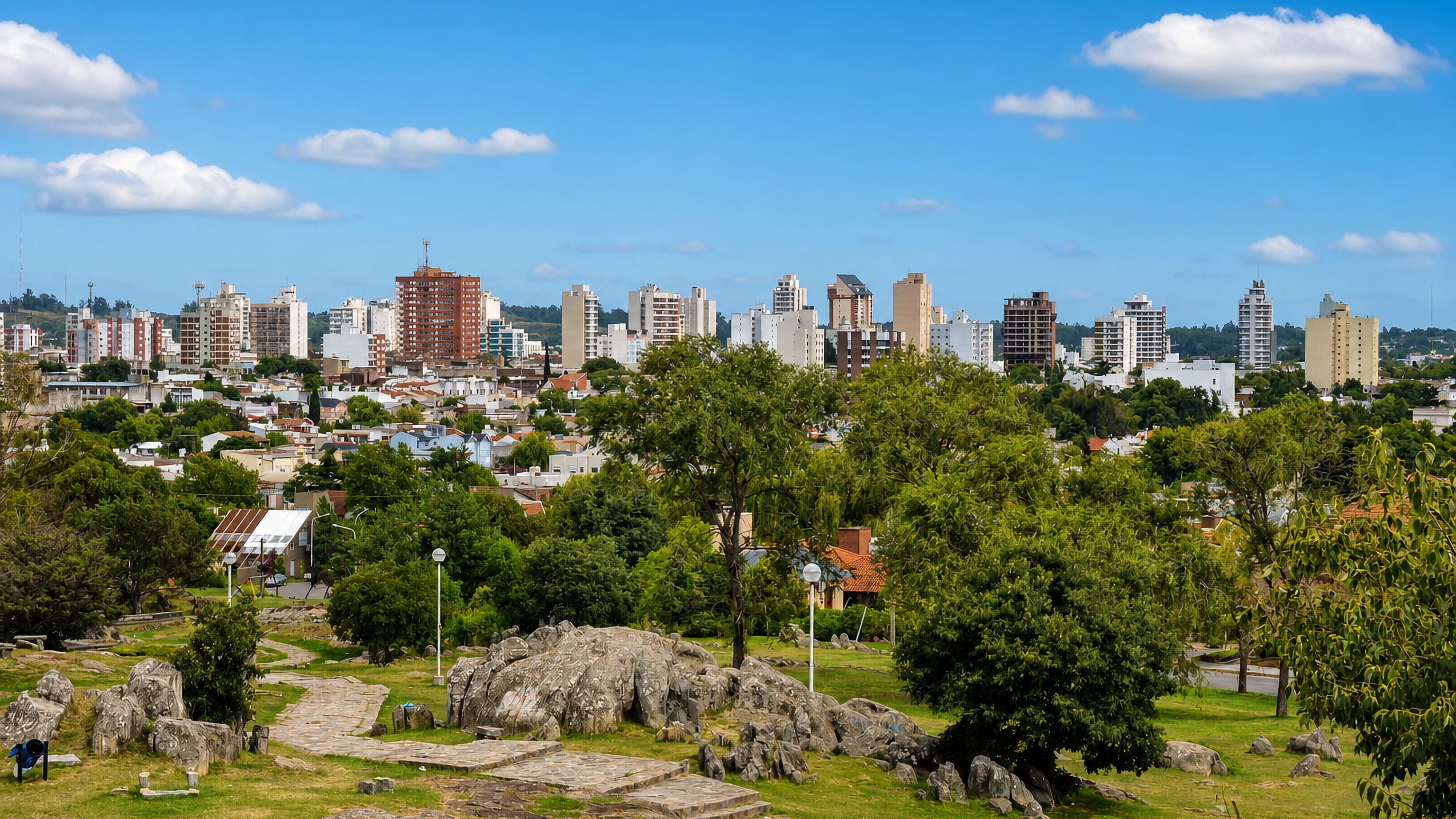 Granite outcrops of Tandil's hillside park overlooking the Argentine city's mid-rise skyline.