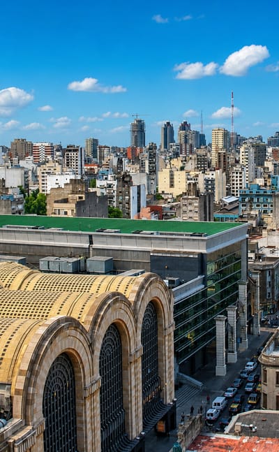 Art Deco vaulted roofs of the historic Abasto market building above the dense Abasto neighborhood of Buenos Aires