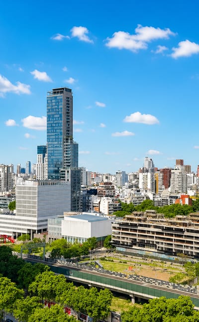 Low-rise tree-lined neighborhood with scattered towers in the Palermo area of Buenos Aires