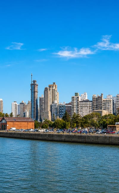 Rosario's Parana riverfront with restored brick port warehouses below modern high-rise apartment towers
