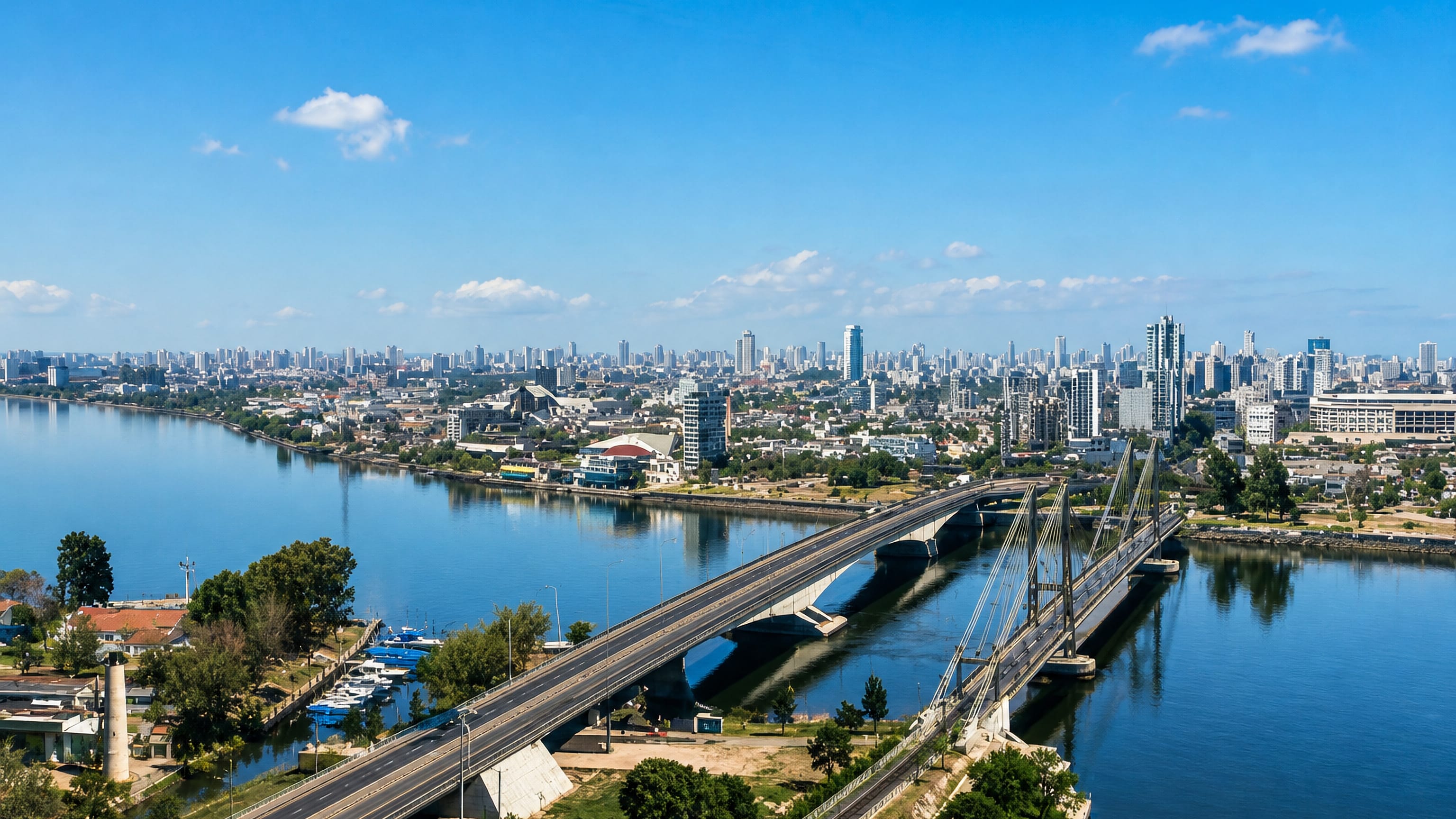 Aerial view of Santa Fe, Argentina, with a cable-stayed bridge crossing the lagoon toward the city skyline.