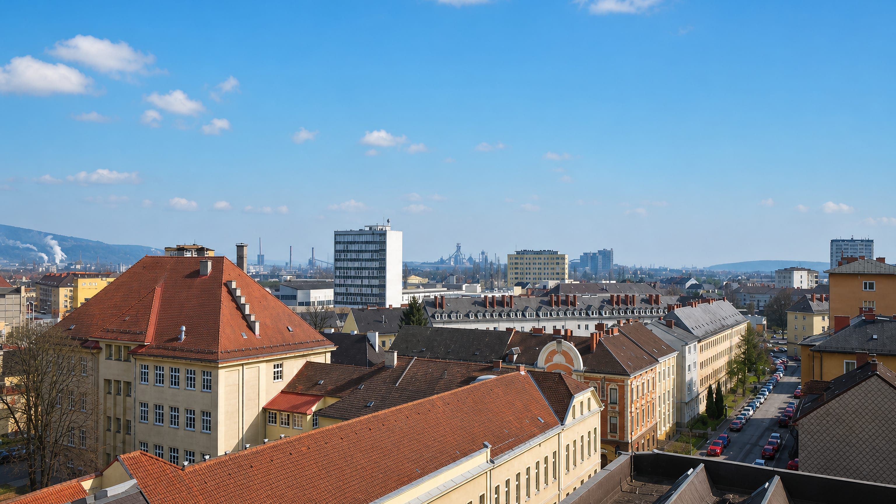 Rooftops of the Bulgariplatz district of Linz with the voestalpine steelworks on the distant horizon.