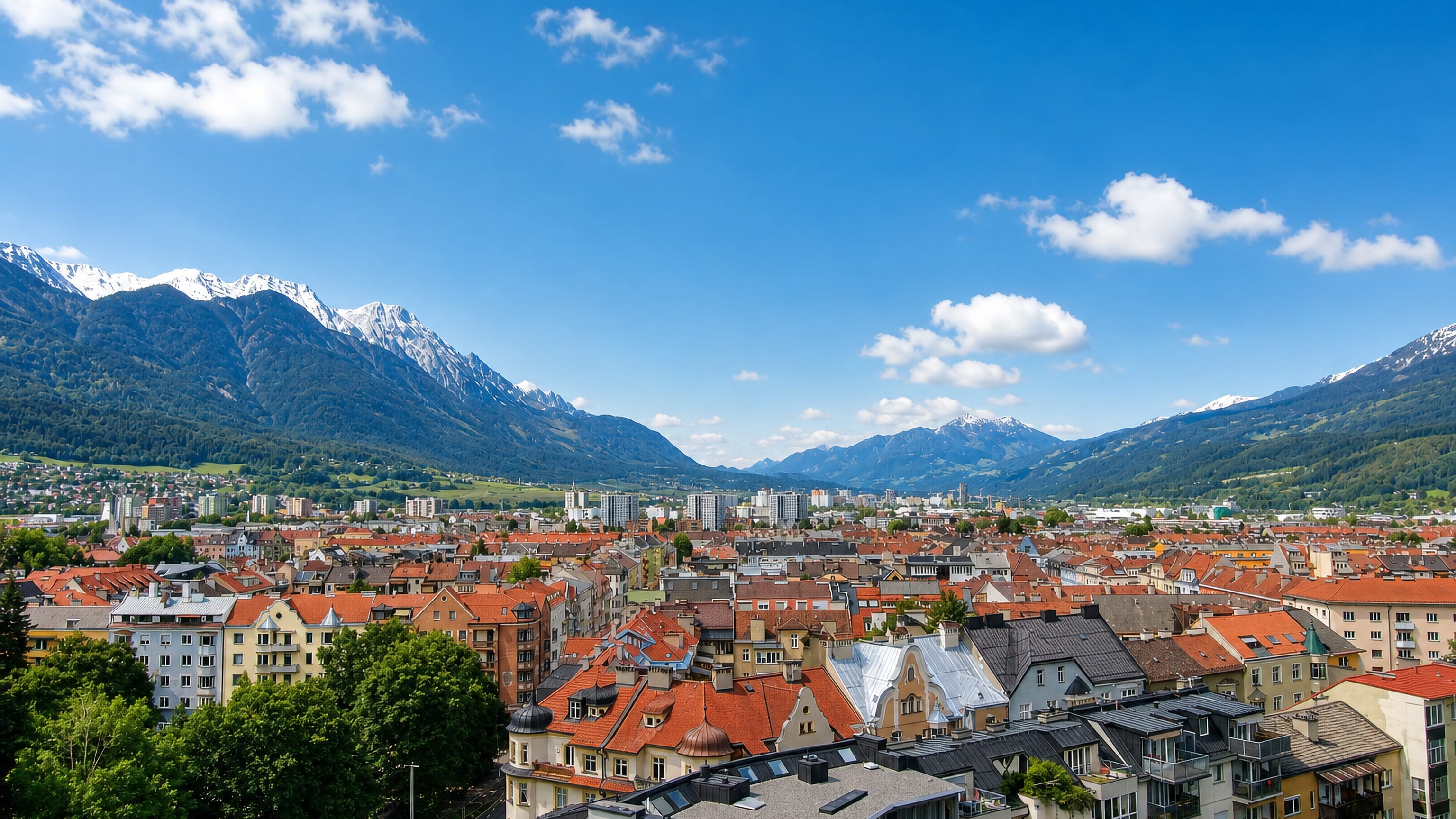 Red-tiled rooftops of Pradl below the snow-capped Nordkette range in Innsbruck, Austria.