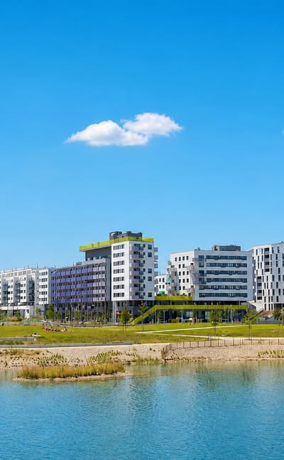 Modern white apartment blocks lining the Aspern lake in the Seestadt district of Vienna