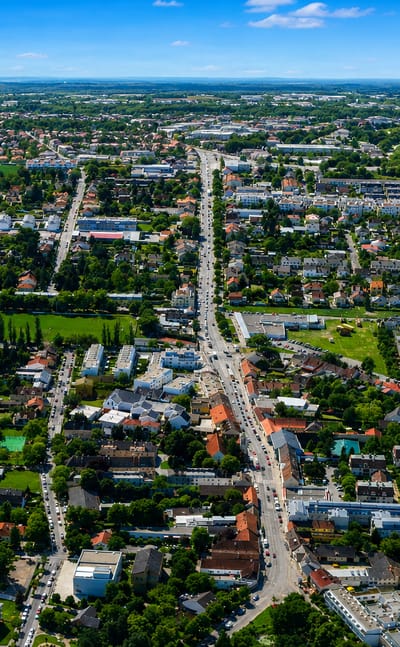 Aerial of the low-rise suburb of Essling on Vienna's eastern edge, with houses giving way to open farmland