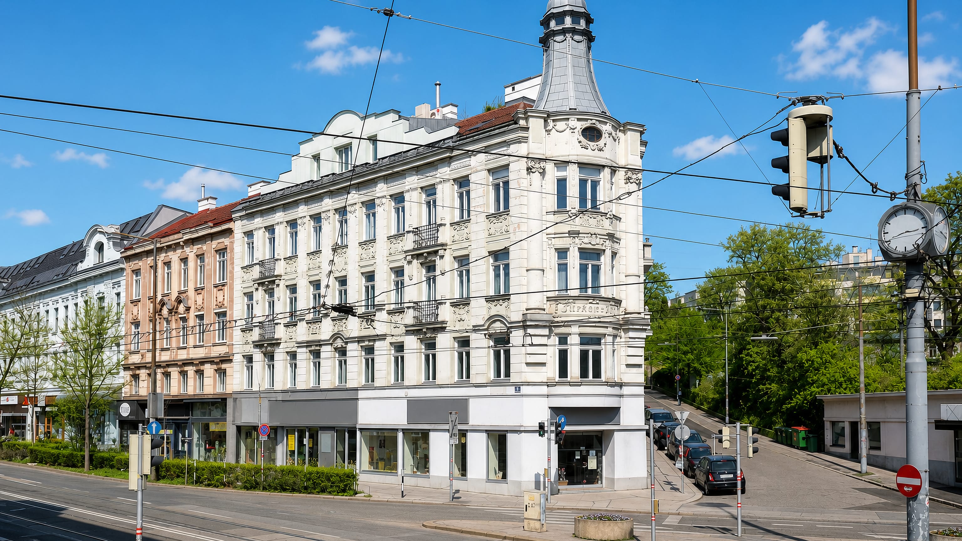 Gründerzeit corner building with a domed turret above a tram-lined crossroads in Gersthof, Vienna.