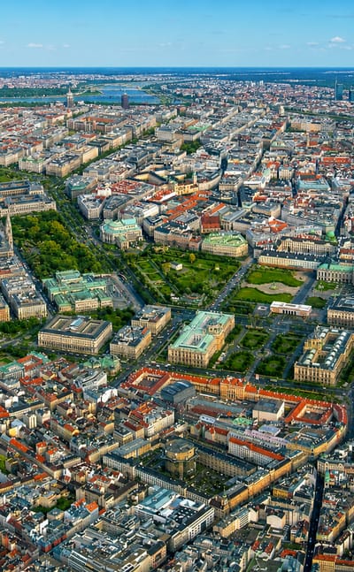 Aerial view of dense inner-Vienna blocks and a large green park in the Josefstadt district