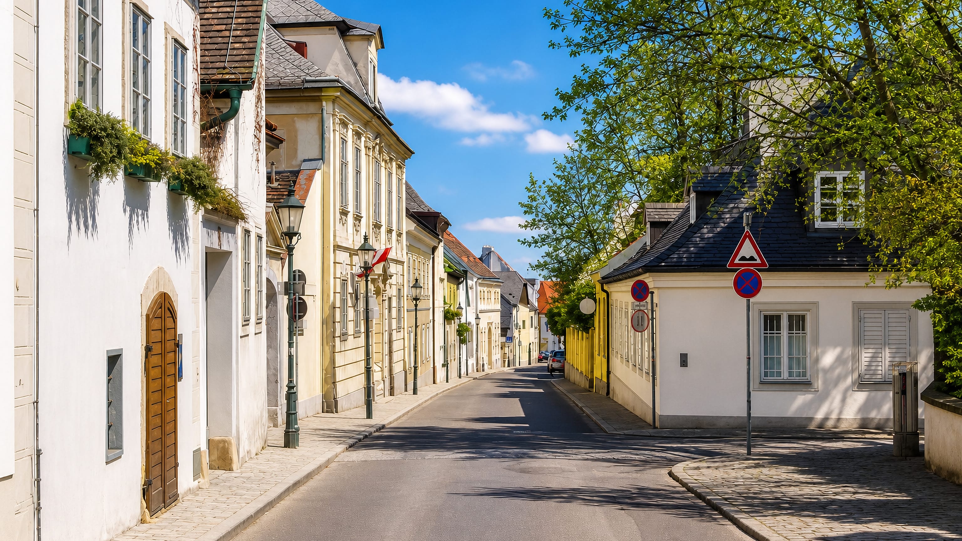 Quiet cobbled lane of pastel village houses in Nussdorf, the wine-growing district of Vienna.