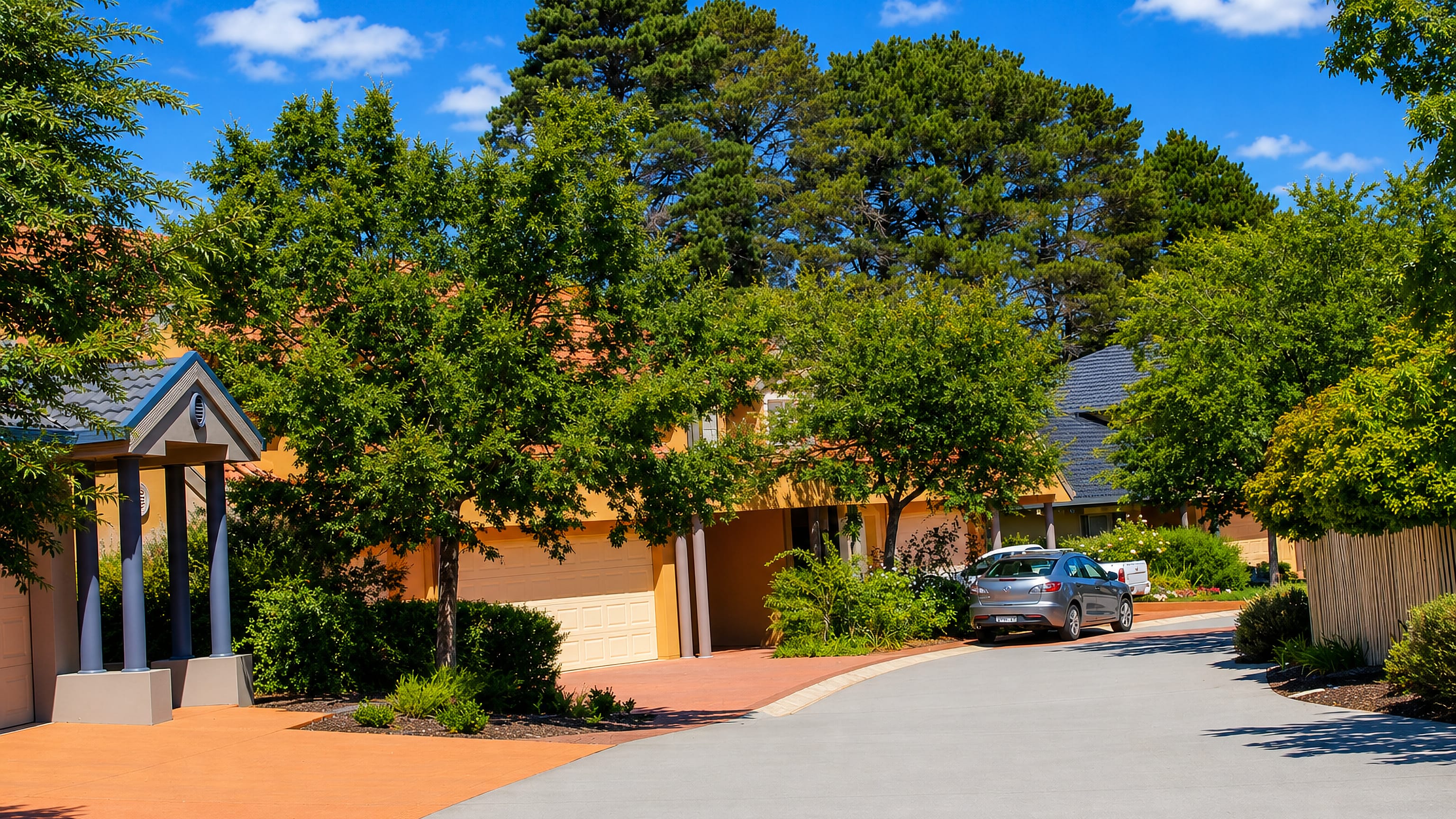 Leafy suburban street with brick houses and a wide driveway in Lyneham, inner north Canberra.