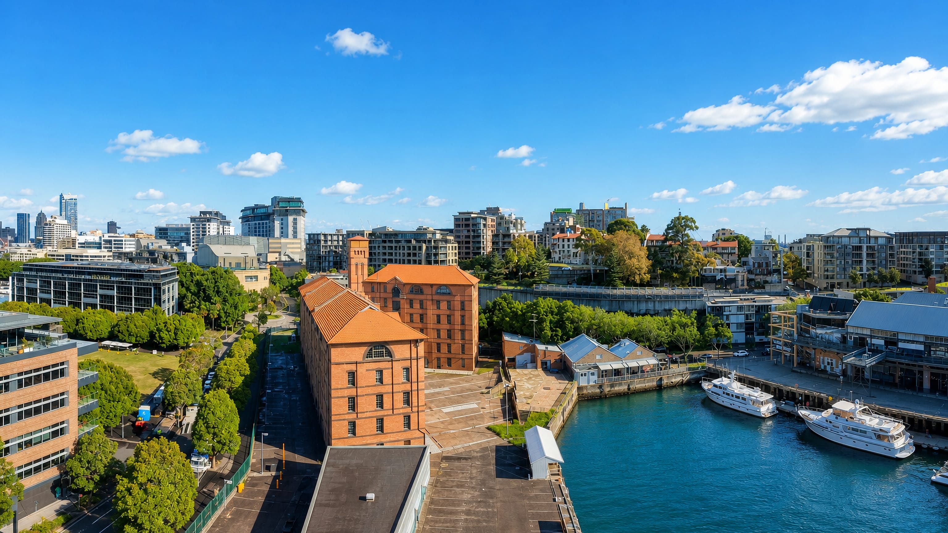 Red-brick heritage warehouse, harbourside marina and apartment towers at Pyrmont in Sydney.