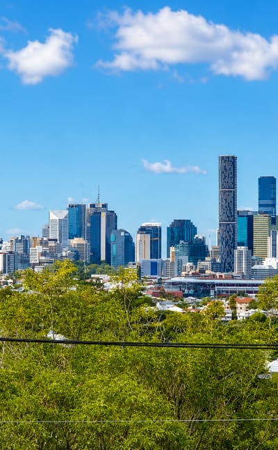 Brisbane city skyline seen over the leafy rooftops of the inner suburb of Paddington.