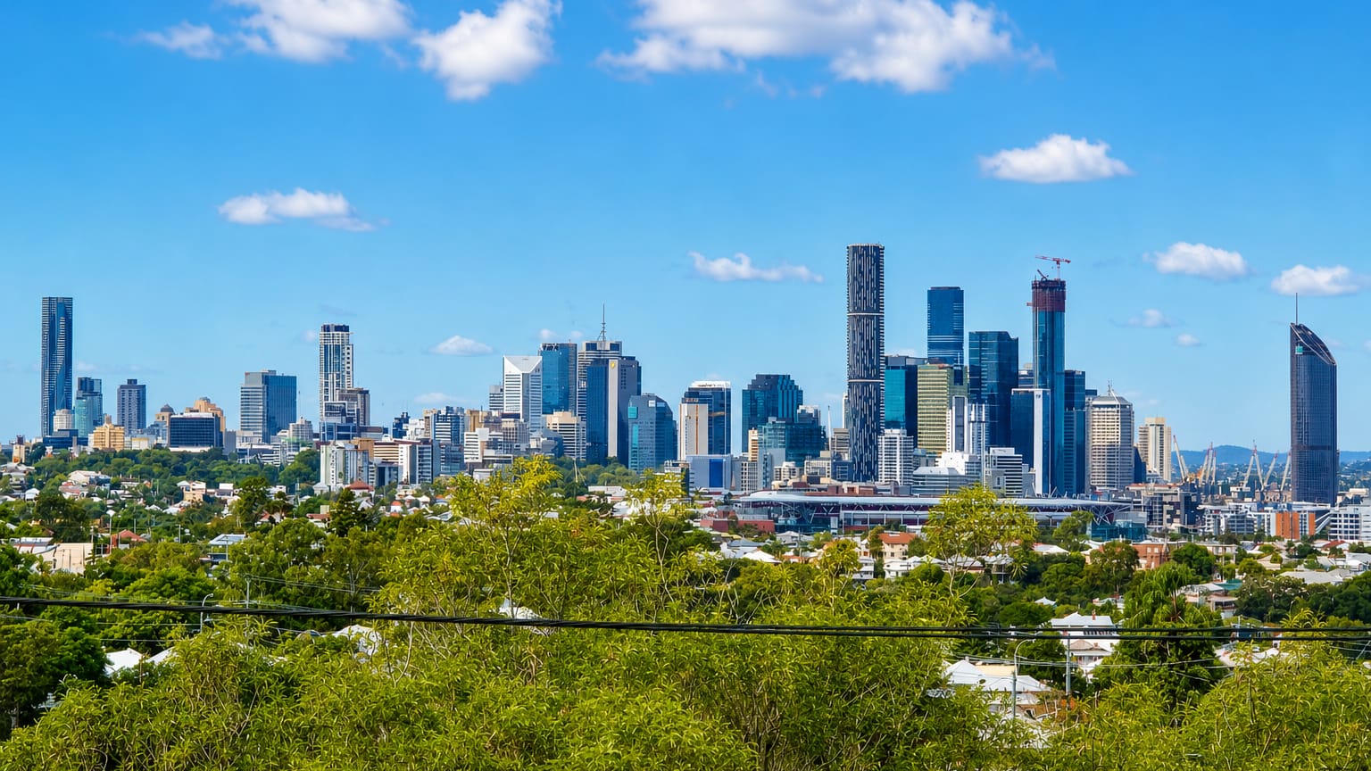 Brisbane city skyline seen over the leafy rooftops of the inner suburb of Paddington.