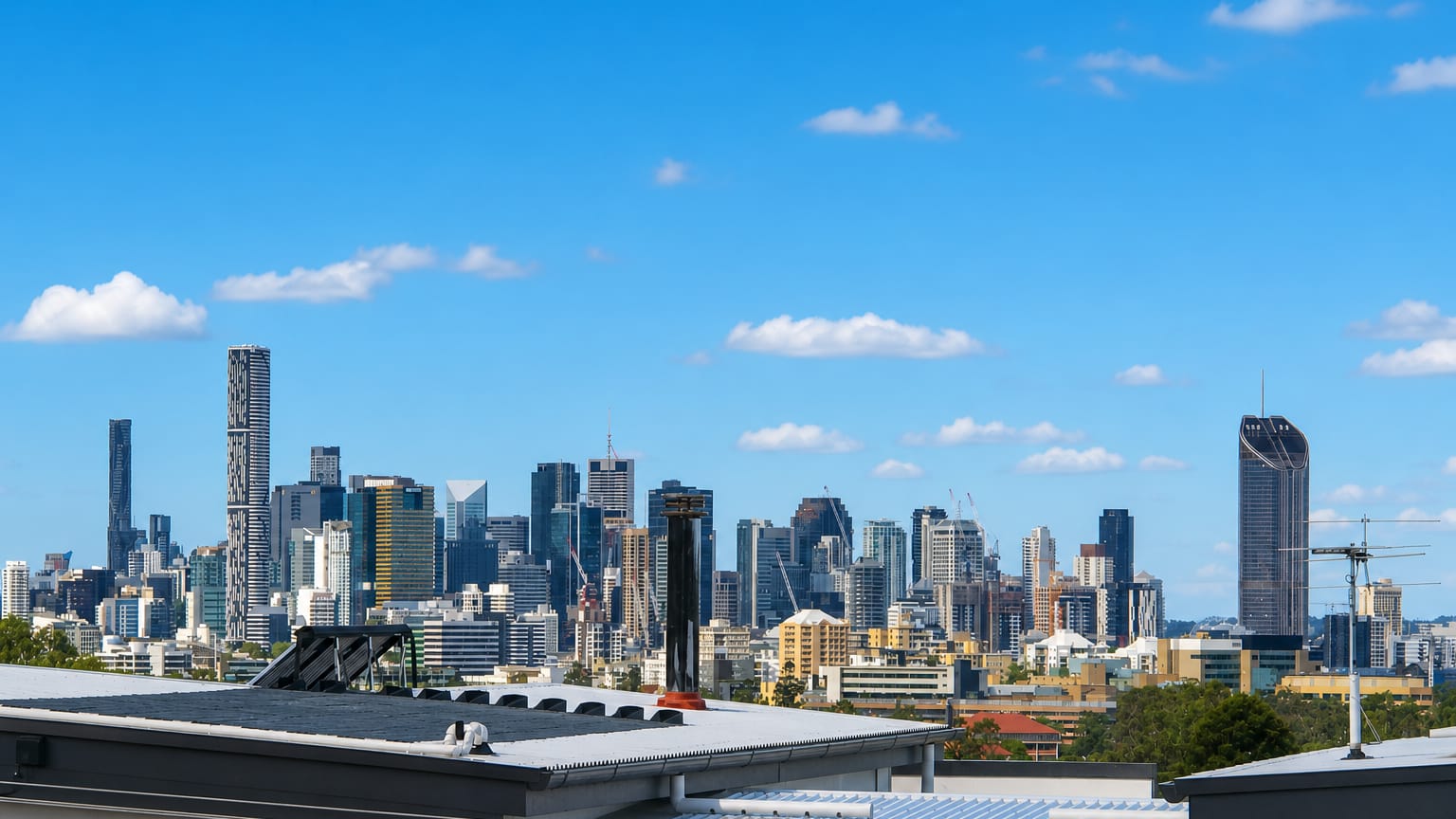 Brisbane's CBD skyline, including its tallest towers, seen across suburban rooftops from Toowong.