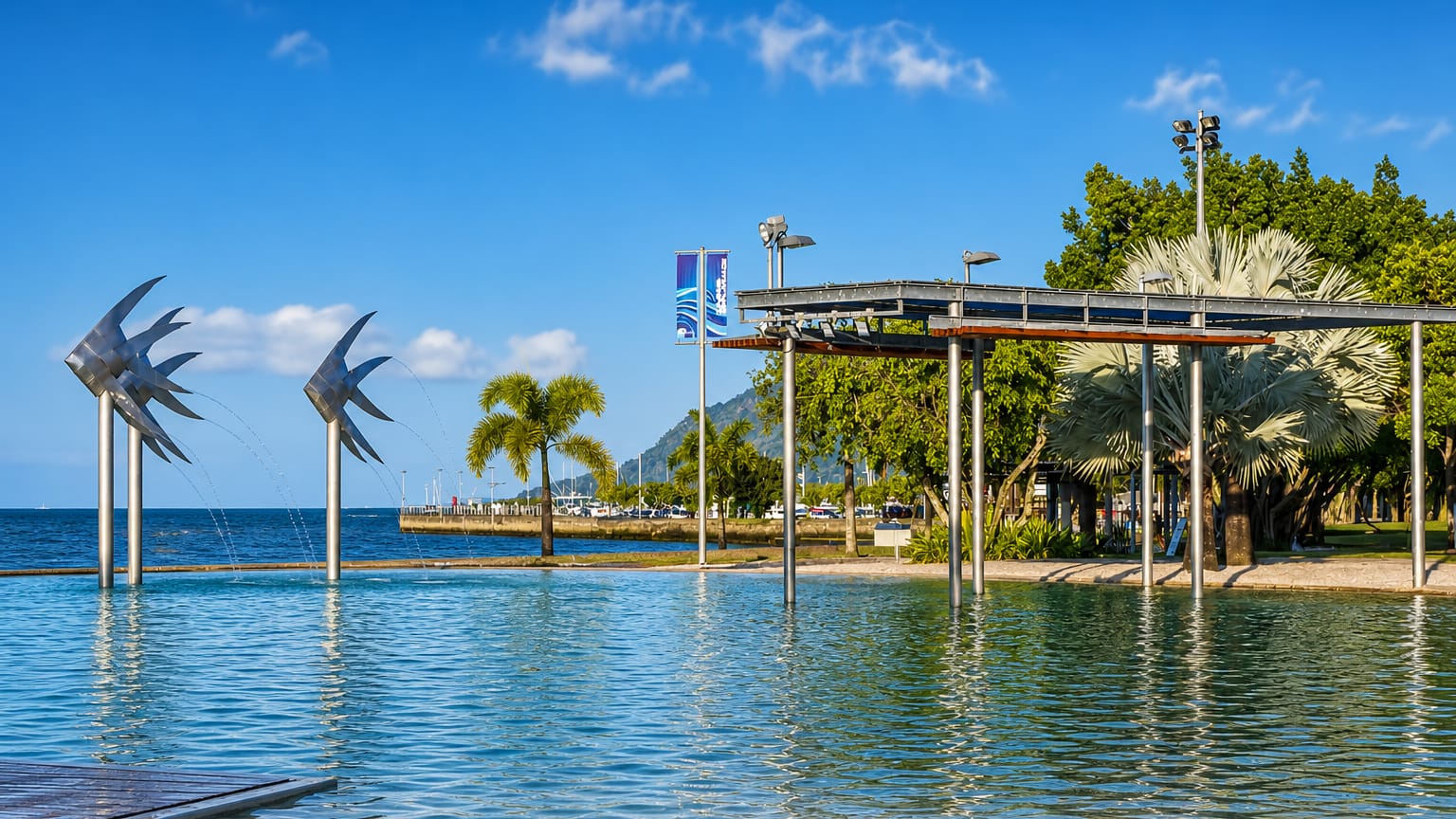 Cairns Esplanade, Queensland, with its fish sculptures and swimming lagoon beside the Coral Sea.