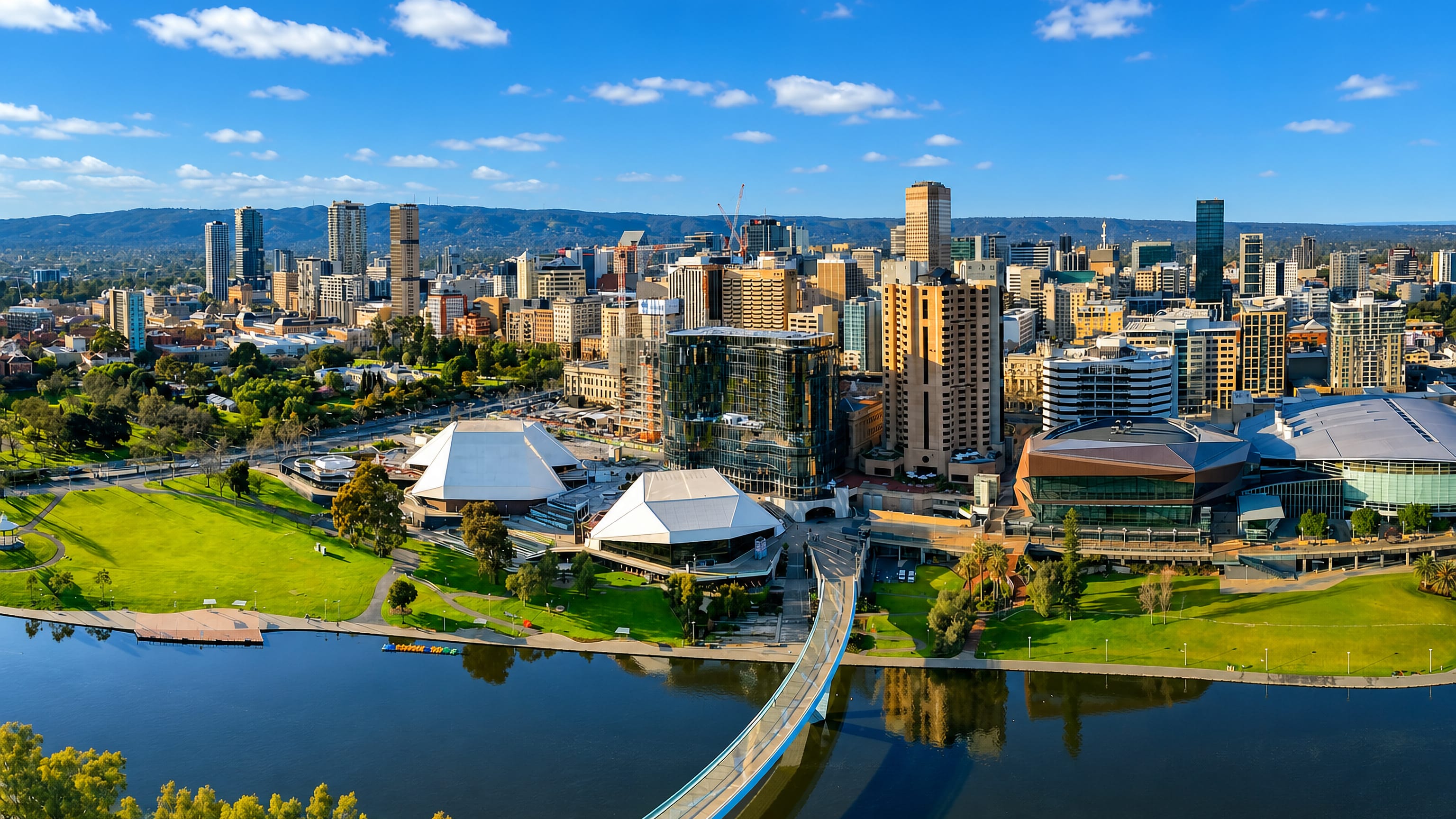 Adelaide city centre skyline above the River Torrens, with the Festival Centre roofs and the footbridge