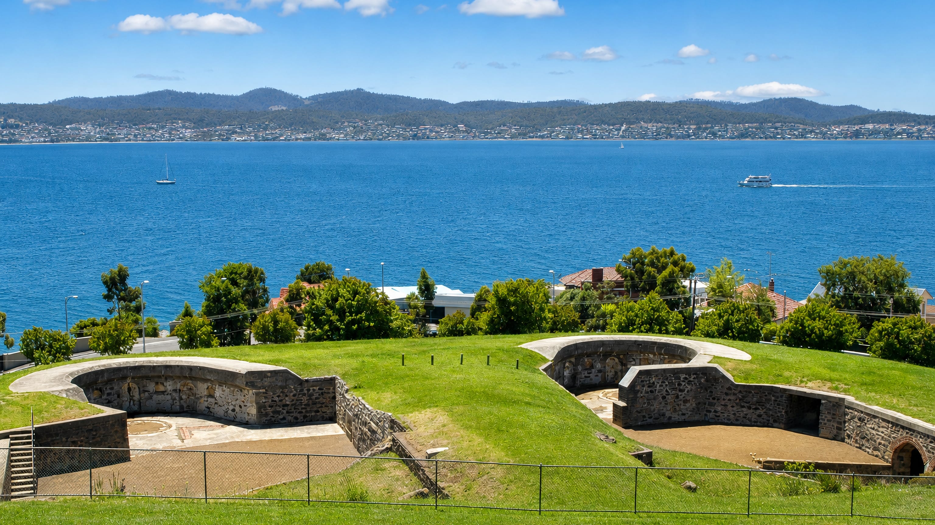 Stone gun emplacements of the historic battery above the blue Derwent estuary at Sandy Bay, Hobart.