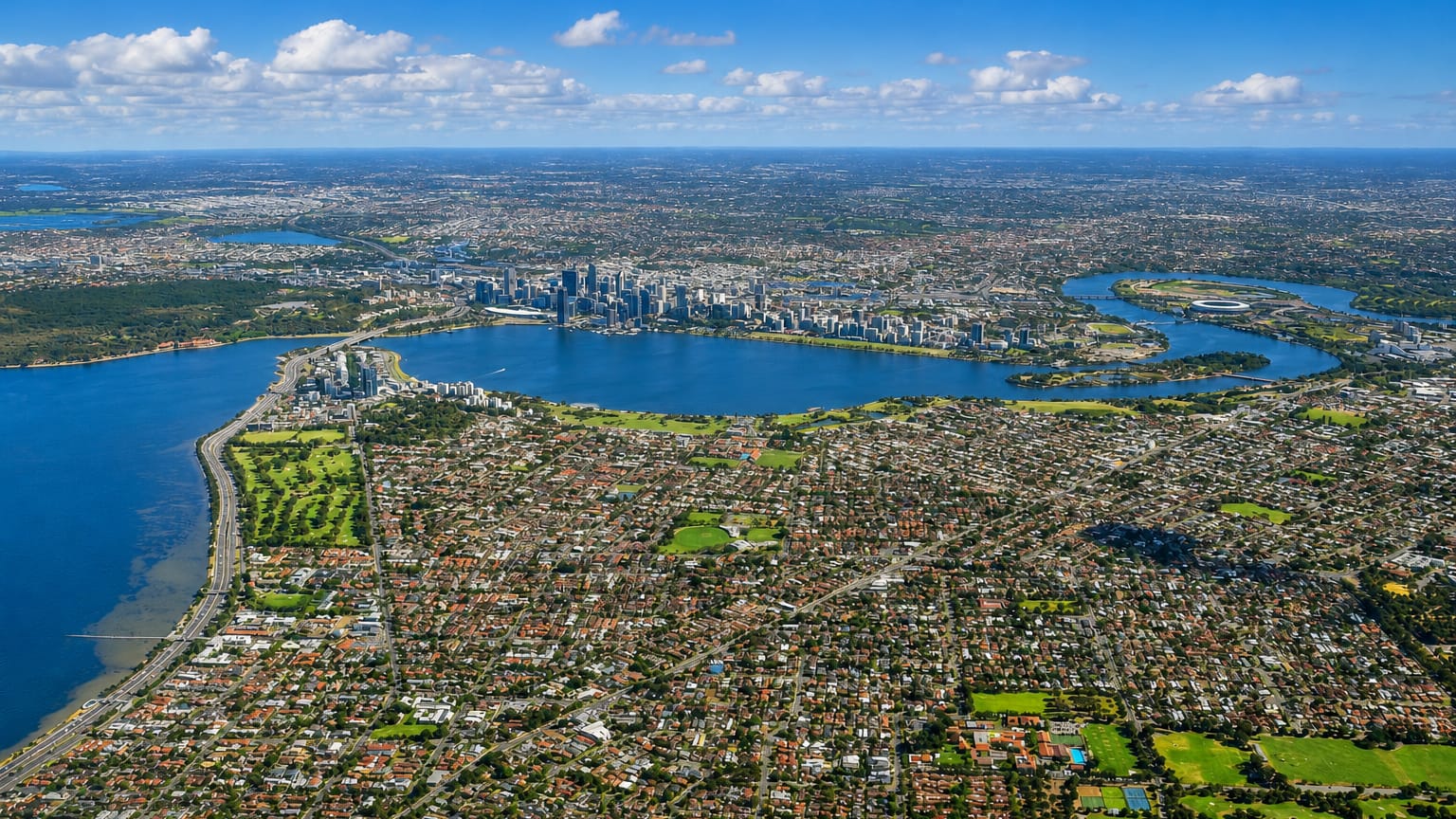 Aerial view of Perth with the Swan River curving past the downtown skyline and surrounding suburbs