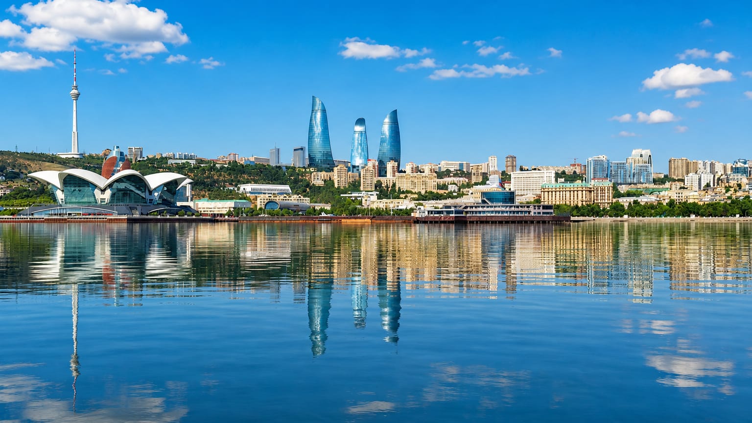 Baku waterfront skyline with the Flame Towers and Baku TV Tower reflected in the Caspian Sea, Azerbaijan.