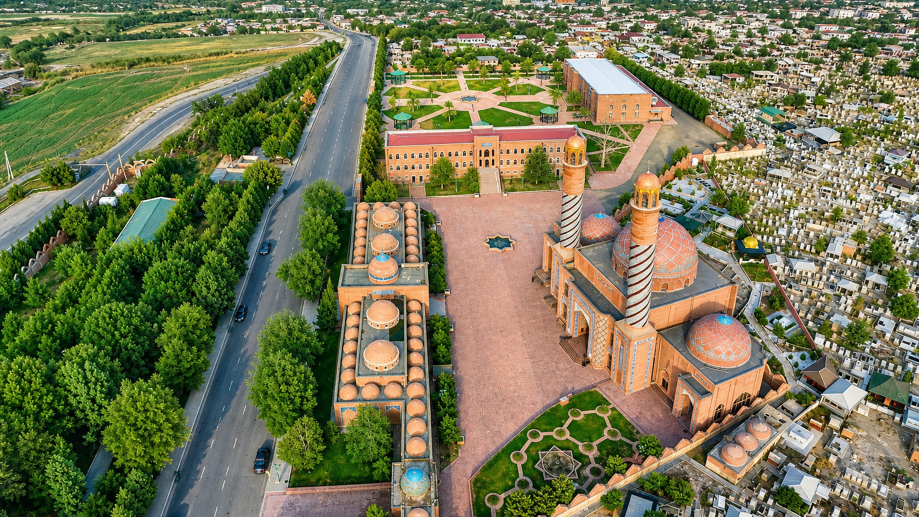 Ganja, Azerbaijan, aerial of the Imamzadeh mausoleum complex with striped minarets, brick domes and gardens.