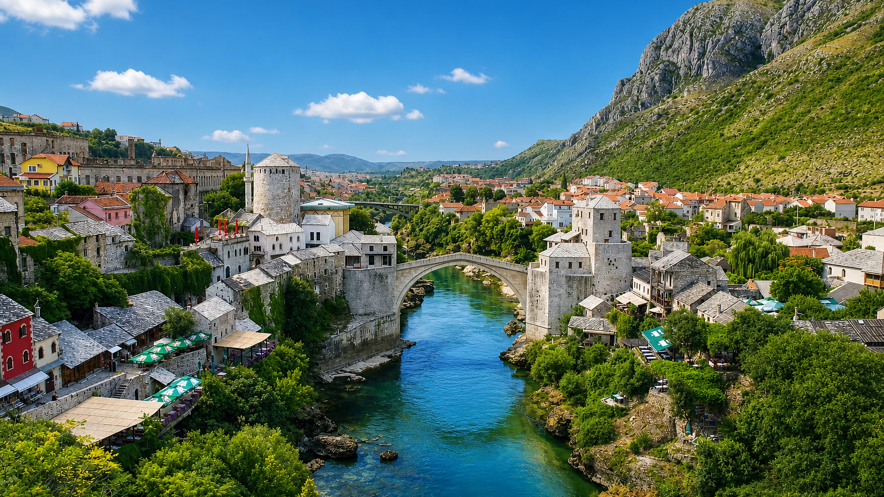 Mostar's arched Stari Most bridge spanning the turquoise Neretva River amid the old town's stone houses.