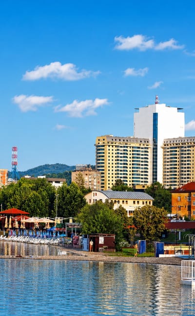 The Pannonian salt lakes and beach in Tuzla, Bosnia and Herzegovina, with high-rise towers behind.