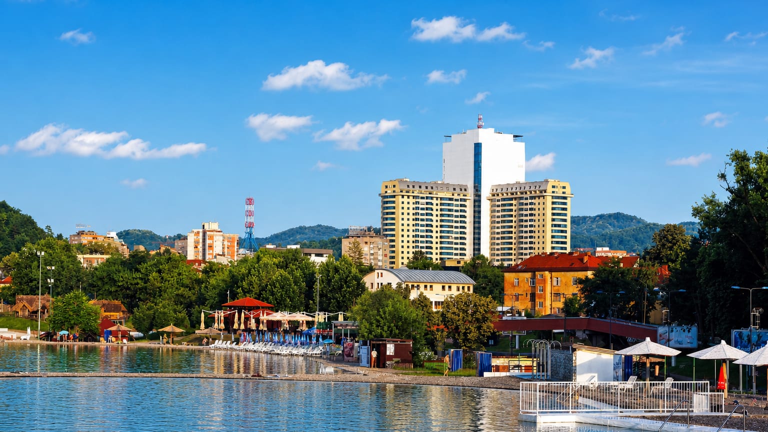 The Pannonian salt lakes and beach in Tuzla, Bosnia and Herzegovina, with high-rise towers behind.