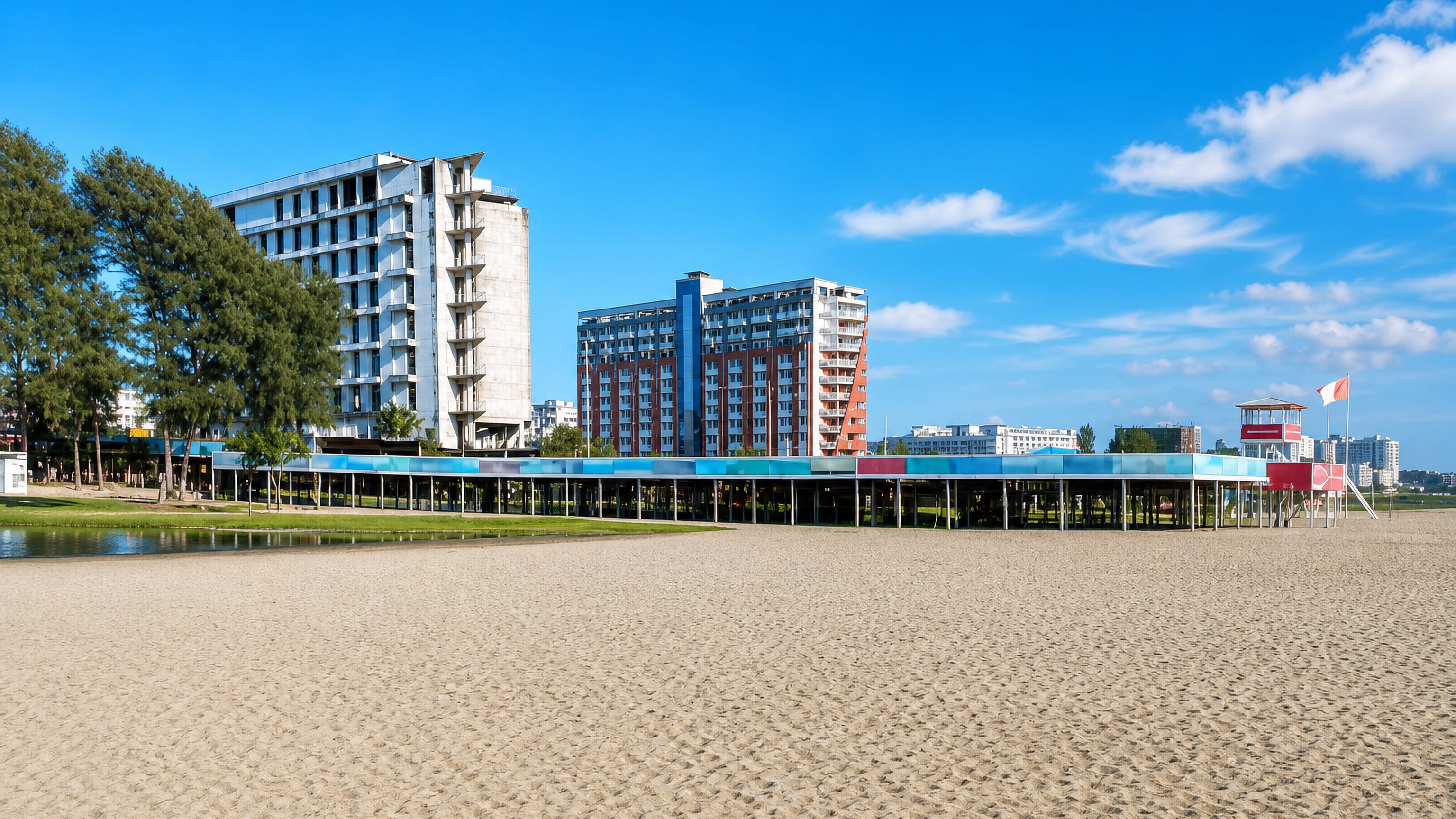A wide sandy beach at Cox's Bazar backed by a colourful beachfront pavilion, lifeguard tower and high-rise hotels.