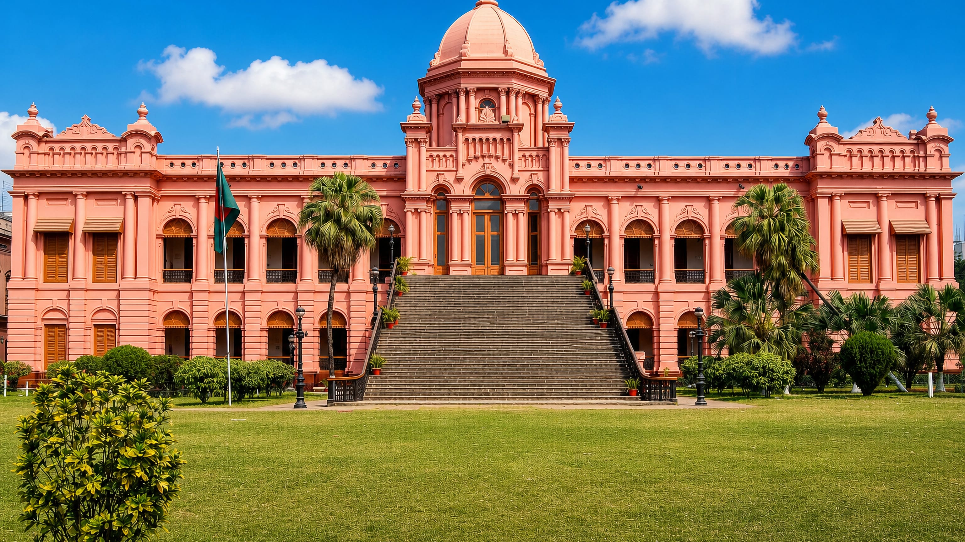 Pink domed Ahsan Manzil palace and its lawn near Bangla Bazar in Old Dhaka, Bangladeshi flag flying