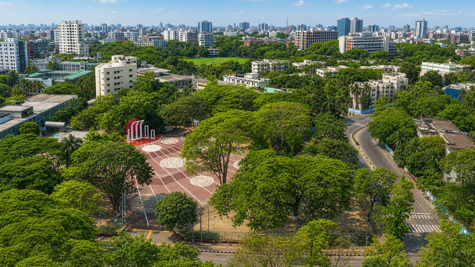Aerial view of the Shaheed Minar monument amid greenery with the central Dhaka skyline behind