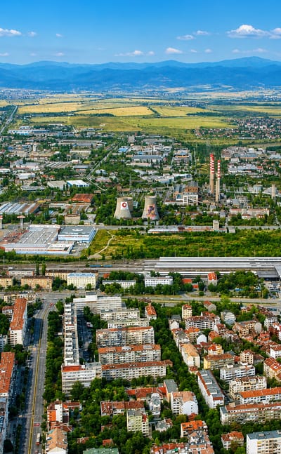 Aerial view of Sofia's Banishora district with rail yards and low-rise blocks on the plain