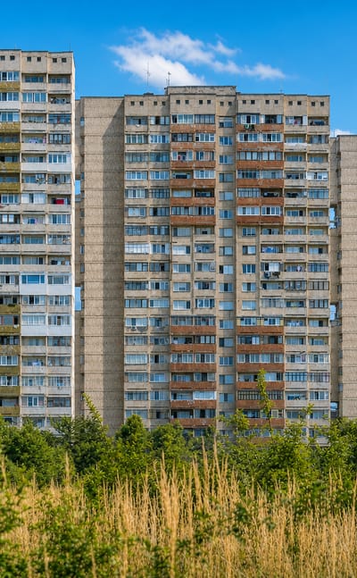 Socialist-era prefab apartment towers backed by mountains in Sofia's Mladost District