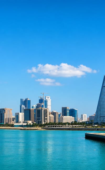 Manama waterfront skyline with the sail-shaped twin towers of the Bahrain World Trade Center.
