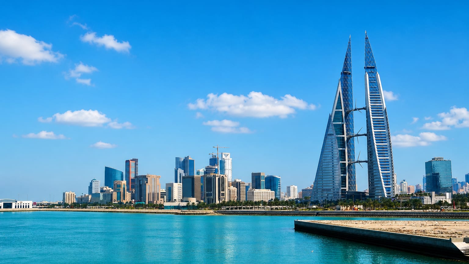 Manama waterfront skyline with the sail-shaped twin towers of the Bahrain World Trade Center.