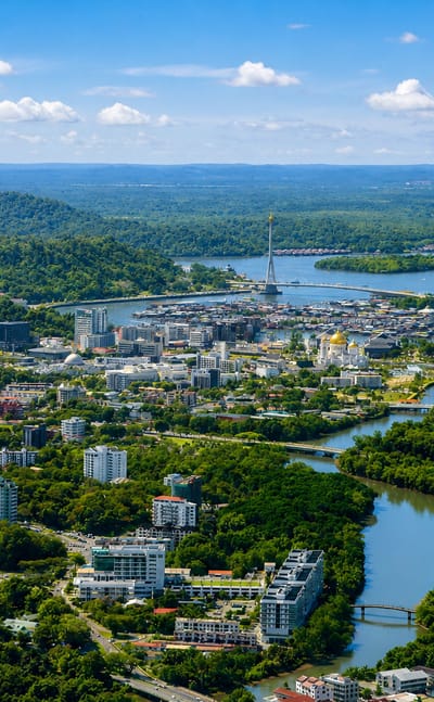 Aerial view of Bandar Seri Begawan with a golden mosque and stilt water village along the Brunei River.