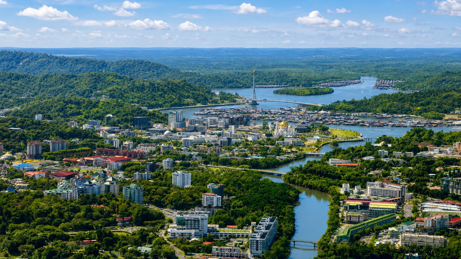 Aerial view of Bandar Seri Begawan with a golden mosque and stilt water village along the Brunei River.