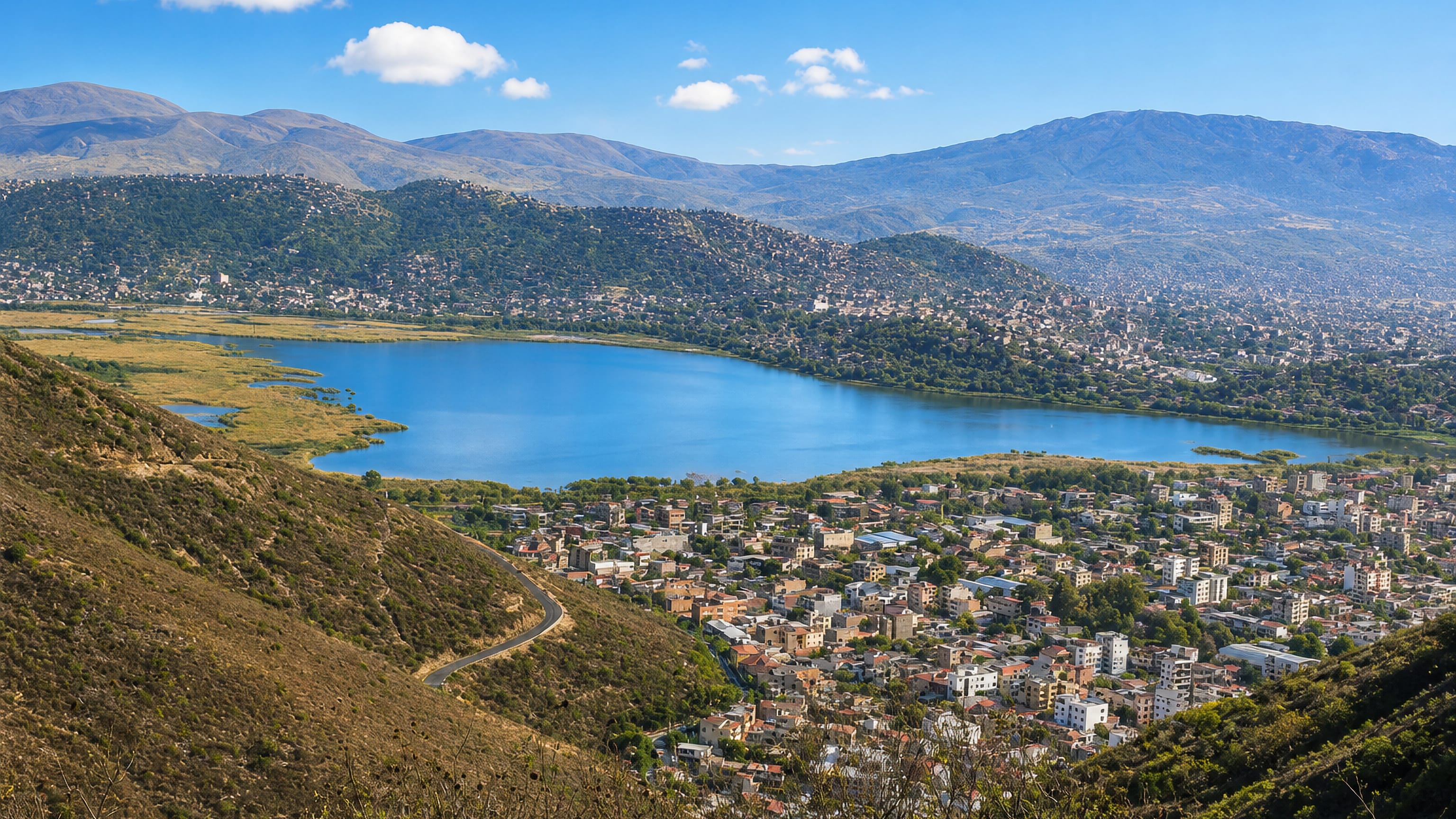 Laguna Alalay and the surrounding city spread below Andean ridges in Cochabamba, Bolivia.