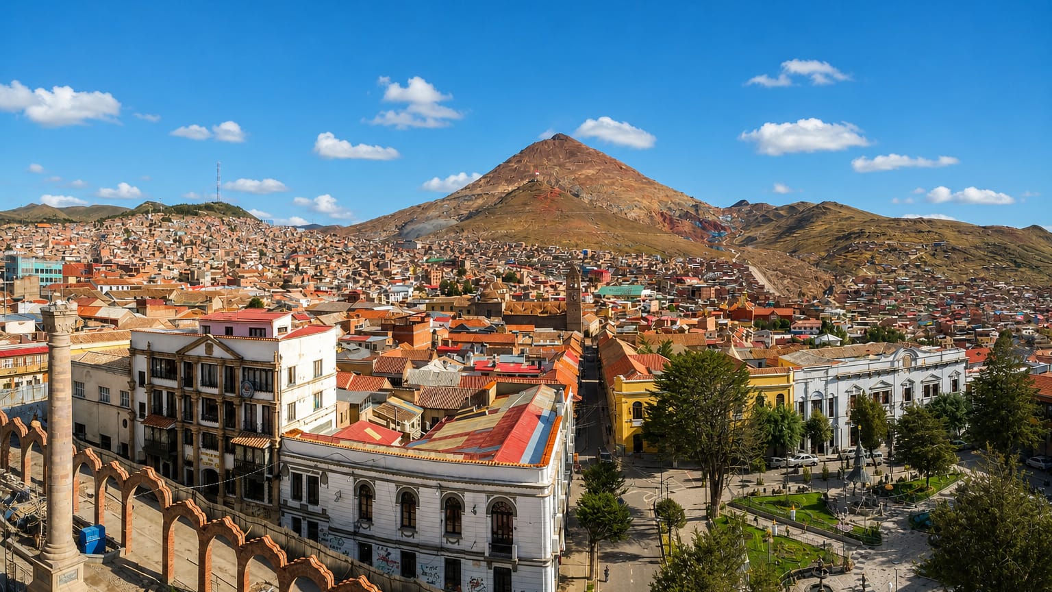 Potosi's terracotta rooftops and colonial plaza below the pyramid-shaped Cerro Rico mountain under a blue sky