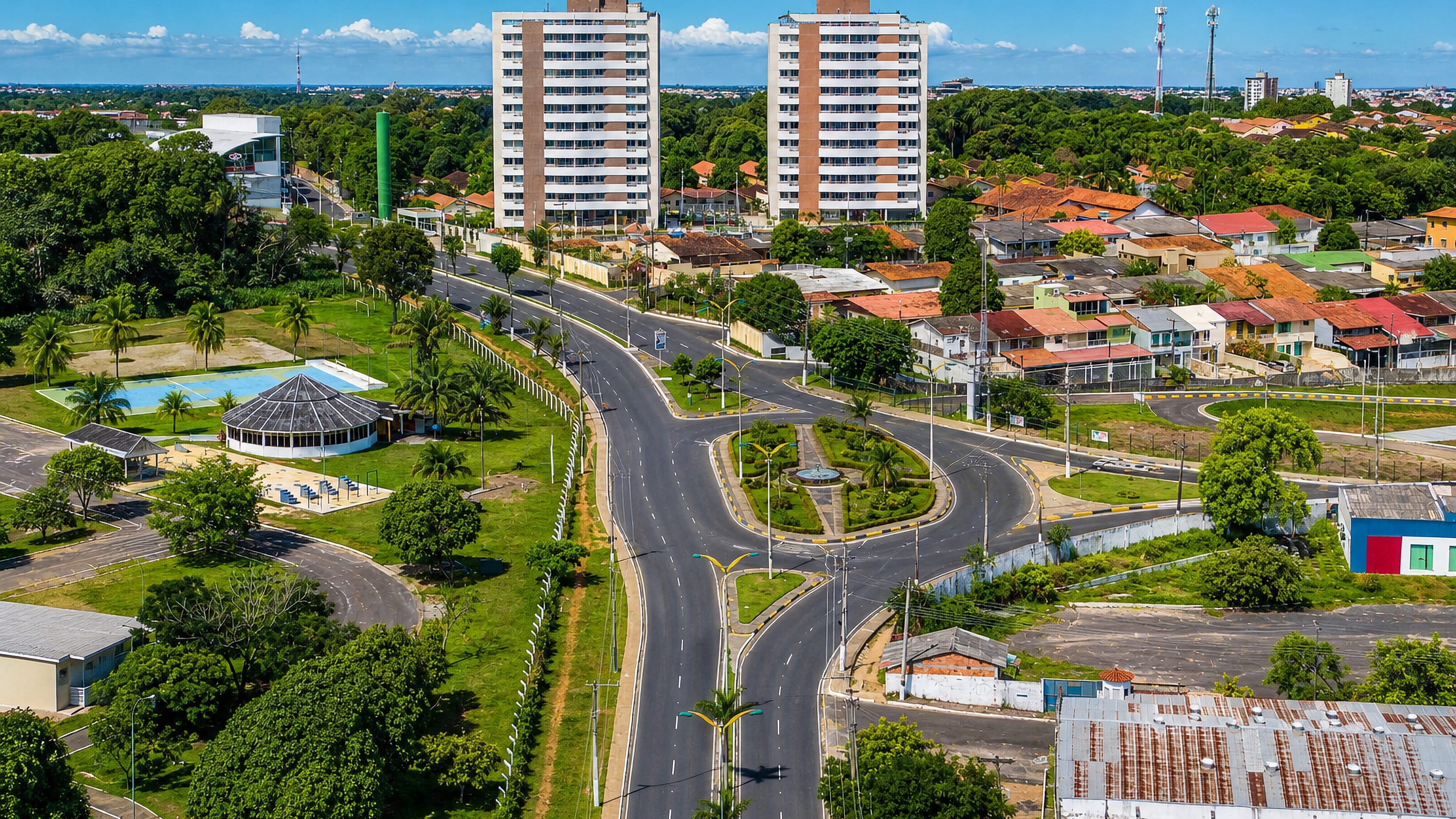 Aerial view of Compensa, Manaus, showing a palm-lined avenue, roundabout and residential towers.