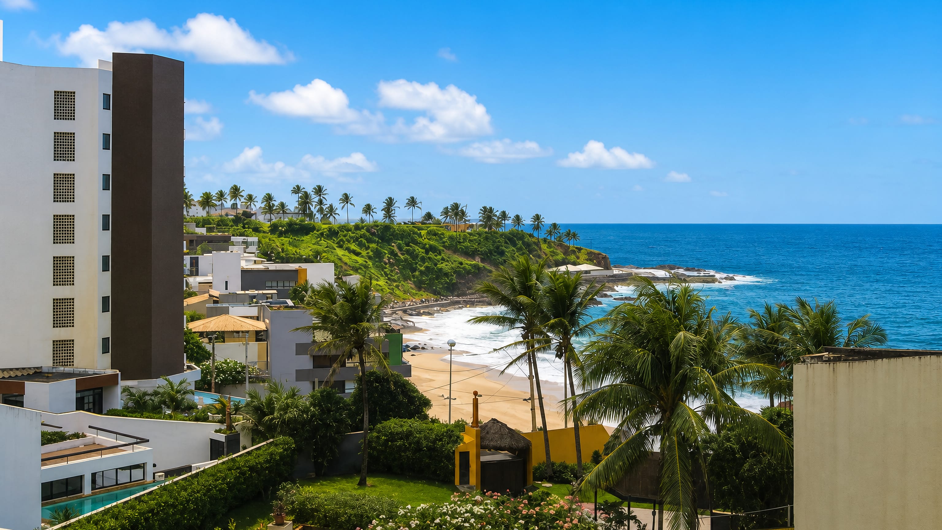 Beach cove, rocky Atlantic shore and palm-lined apartment blocks in Amaralina, Salvador, Brazil