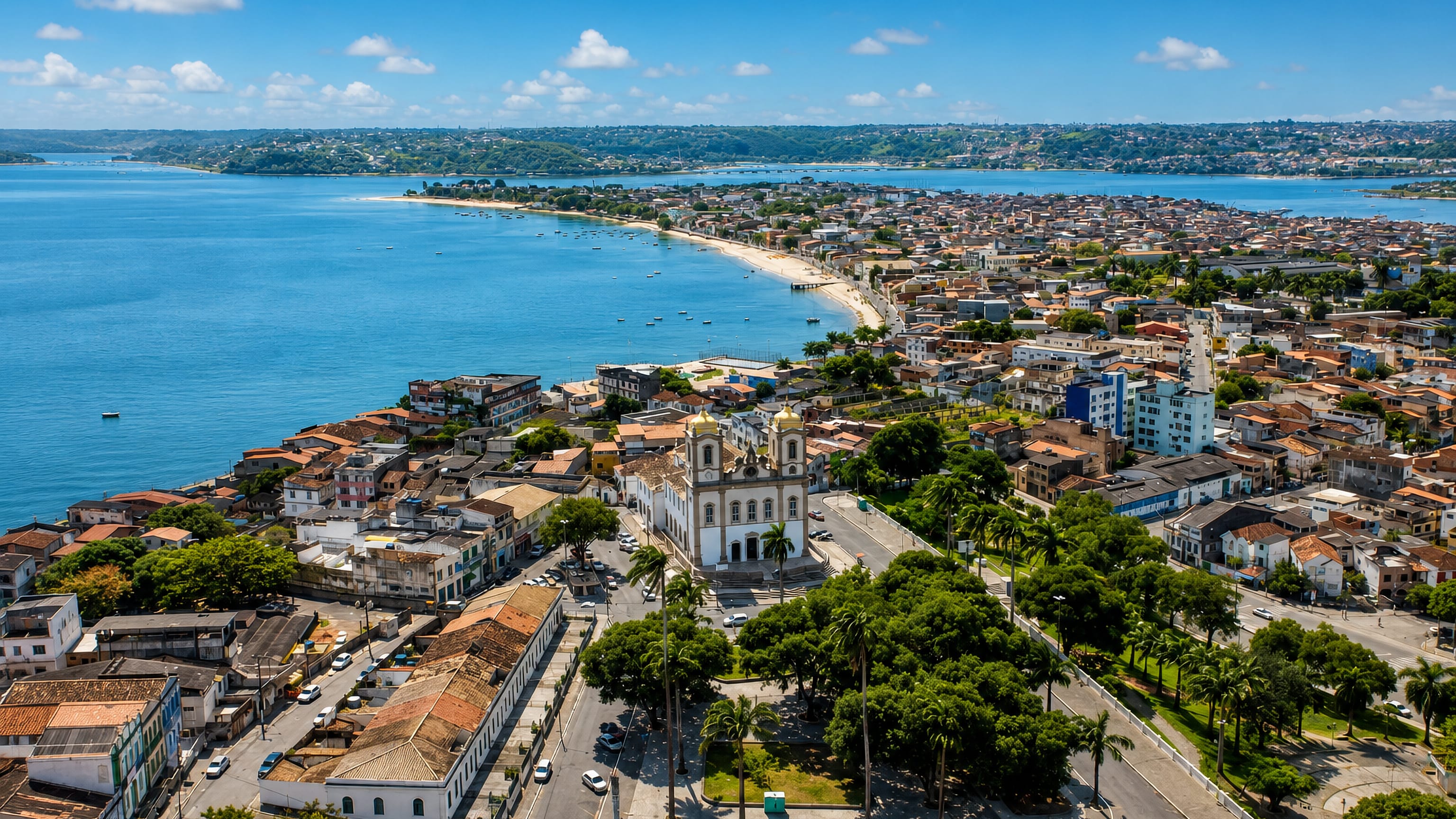 Aerial view over Bonfim in Salvador, its hilltop basilica above the Itapagipe shoreline and bay.