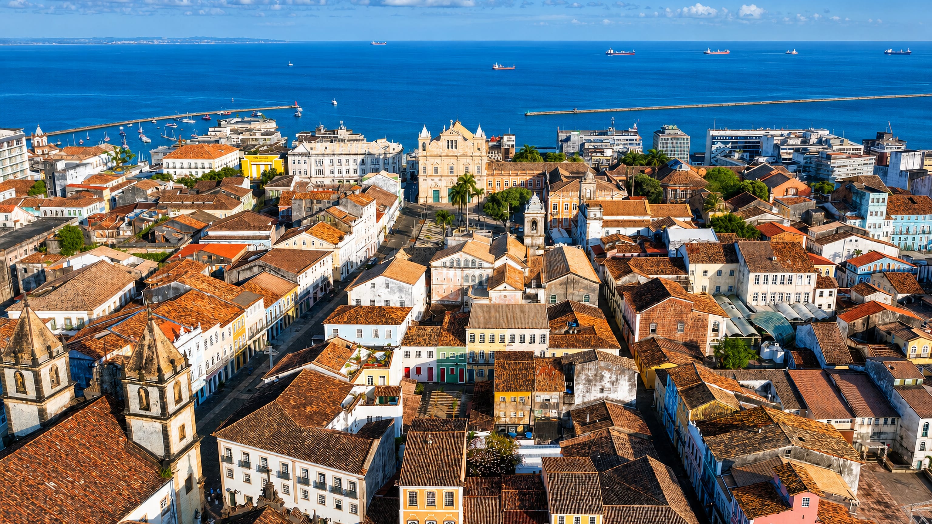Salvador's Pelourinho rooftops, colonial church towers and pastel facades above the Bay of All Saints.