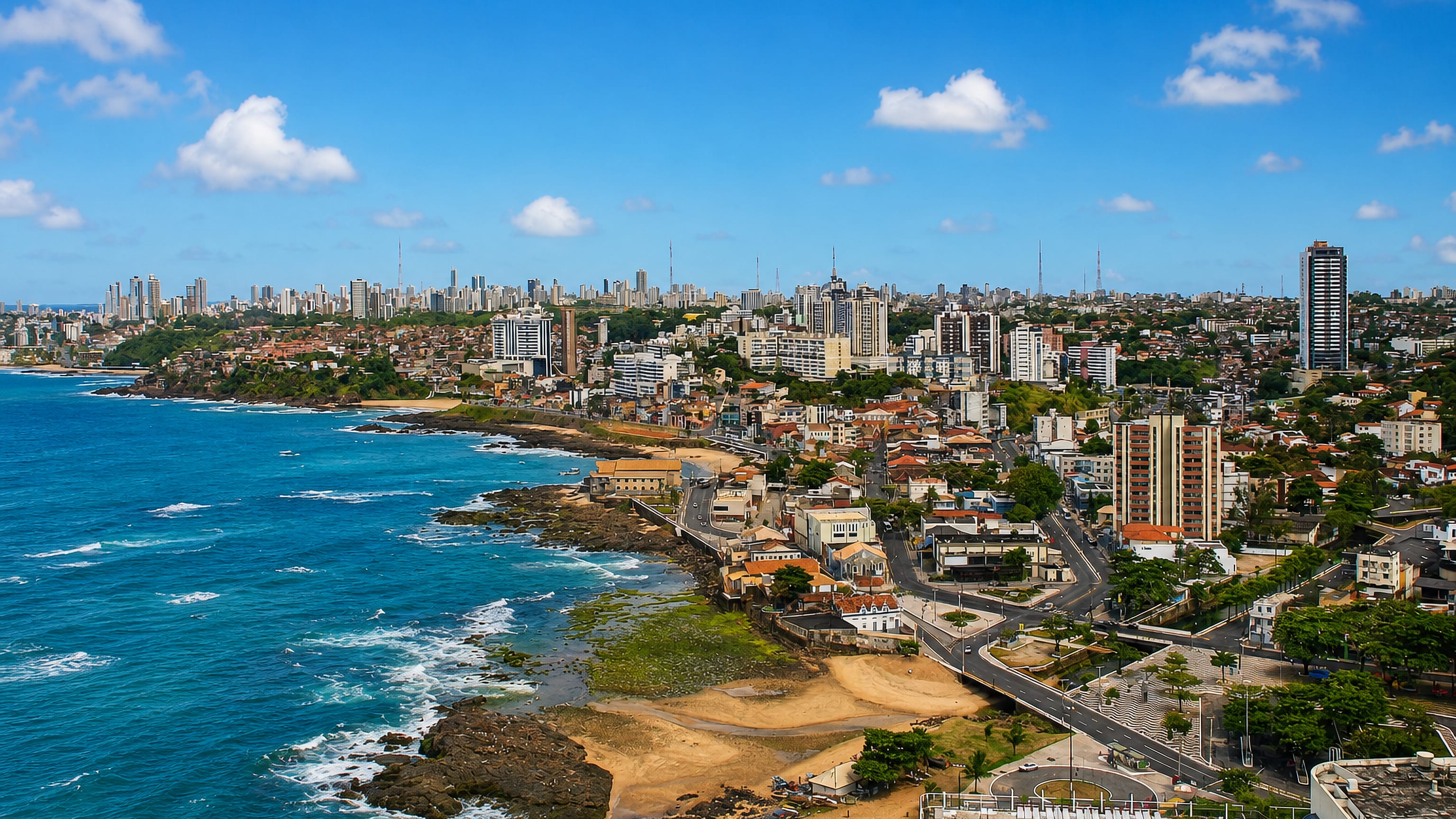 Rocky coves and beachfront apartment blocks of Rio Vermelho along Salvador's Atlantic shoreline.