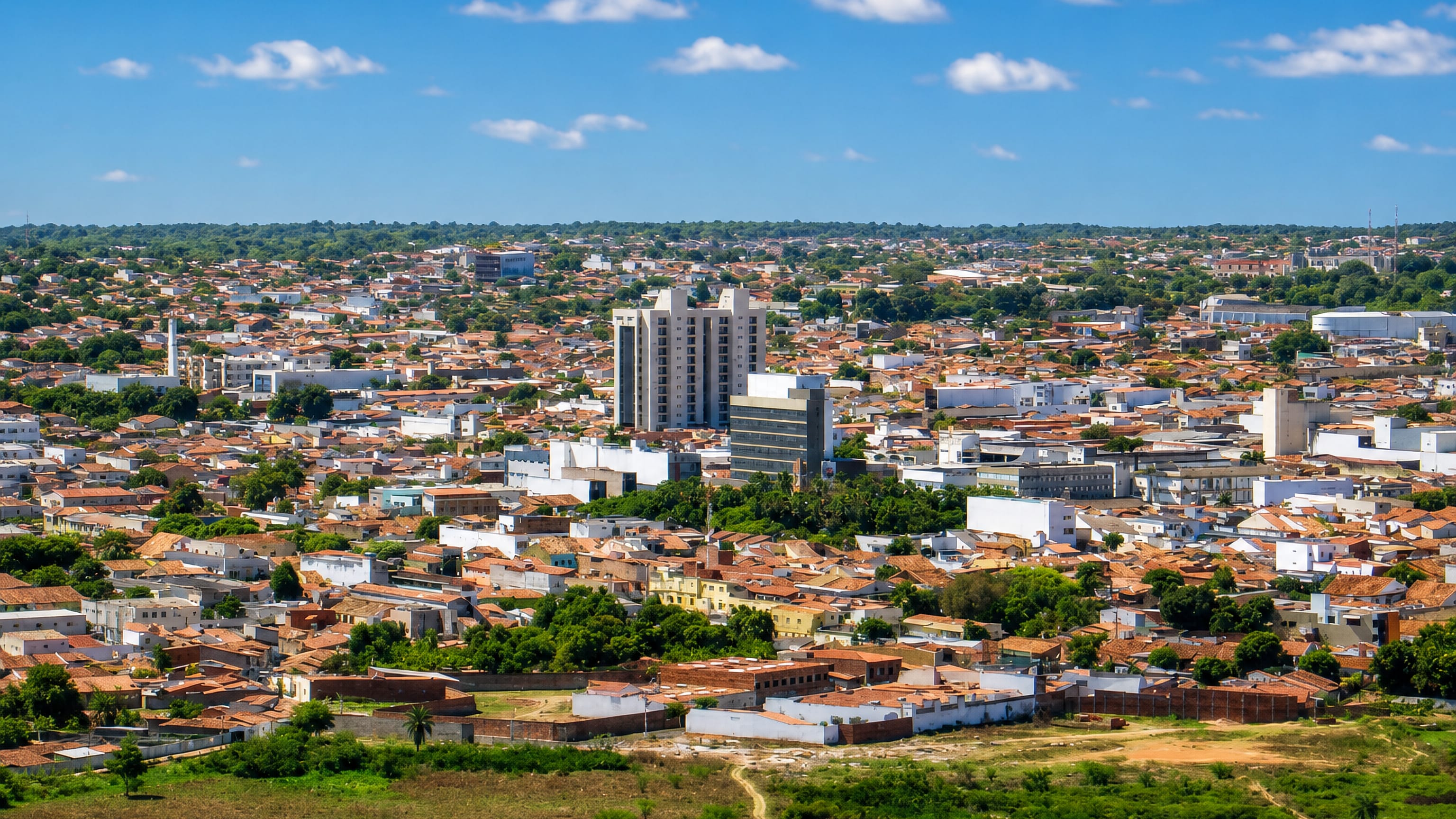 Aerial view of Juazeiro do Norte, Brazil, red-tiled rooftops and tower blocks spreading across the Ceará sertão.