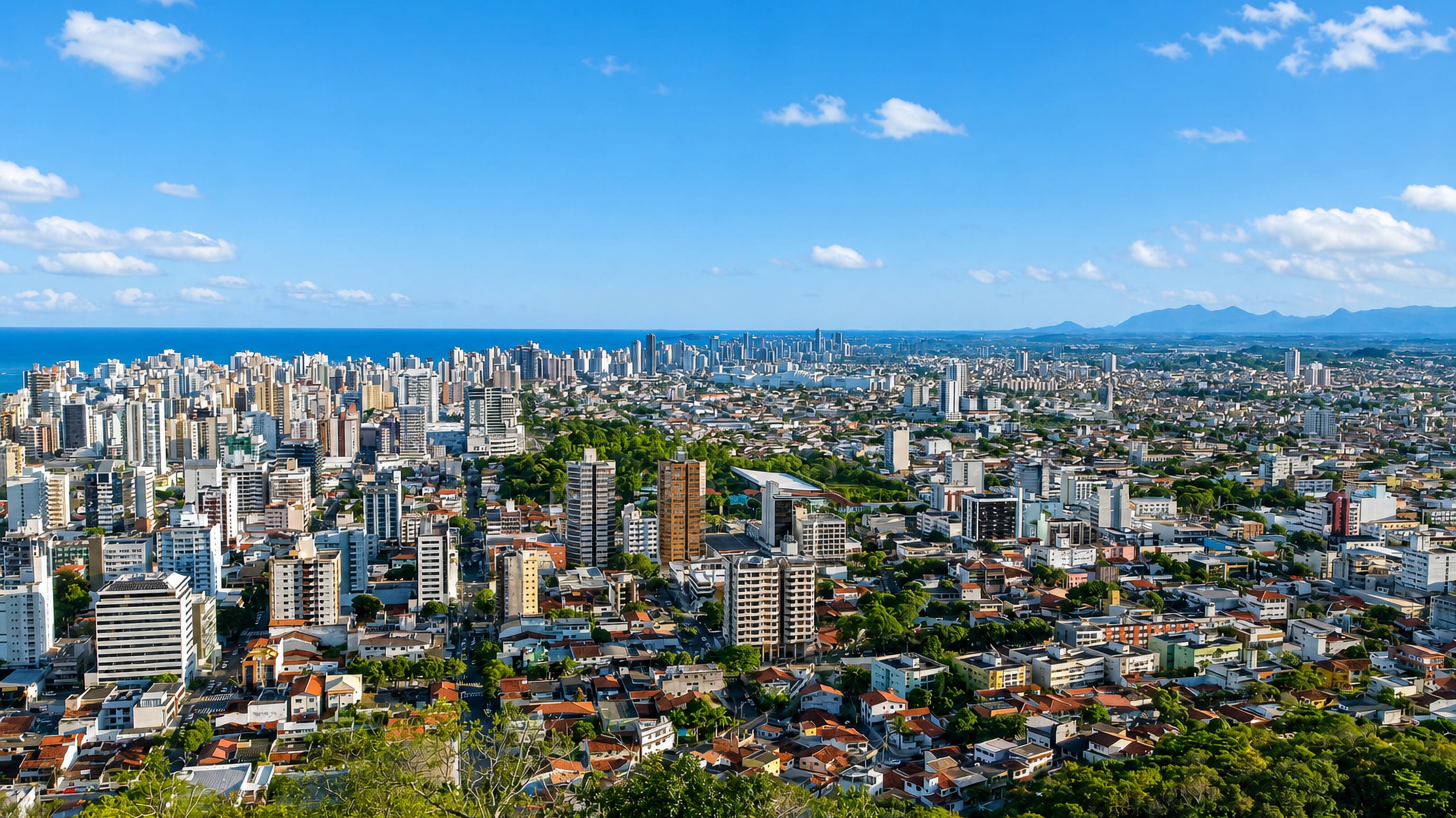 High-rise skyline of Vila Velha, Brazil, stretching along the Atlantic coast under a clear blue sky.