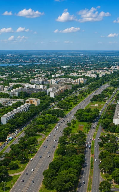 Aerial of Brasilia showing the twin dark towers of the Banco Central above the monumental axis and Lake Paranoa